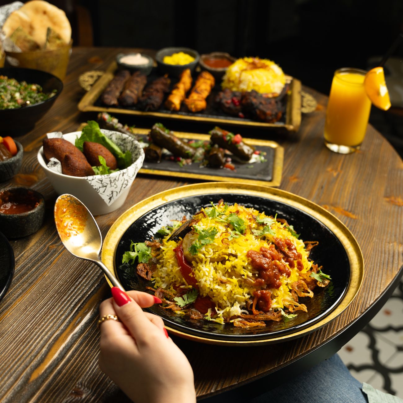 A platter of saffron rice with a wedge of golden crisp tahdig lifted onto the top